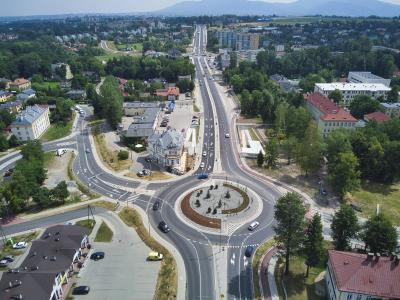 Zdjęcie przedstawiające duże rondo z instalacją pośrodku, widziane z lotu ptaka, otoczone miejską zabudową.